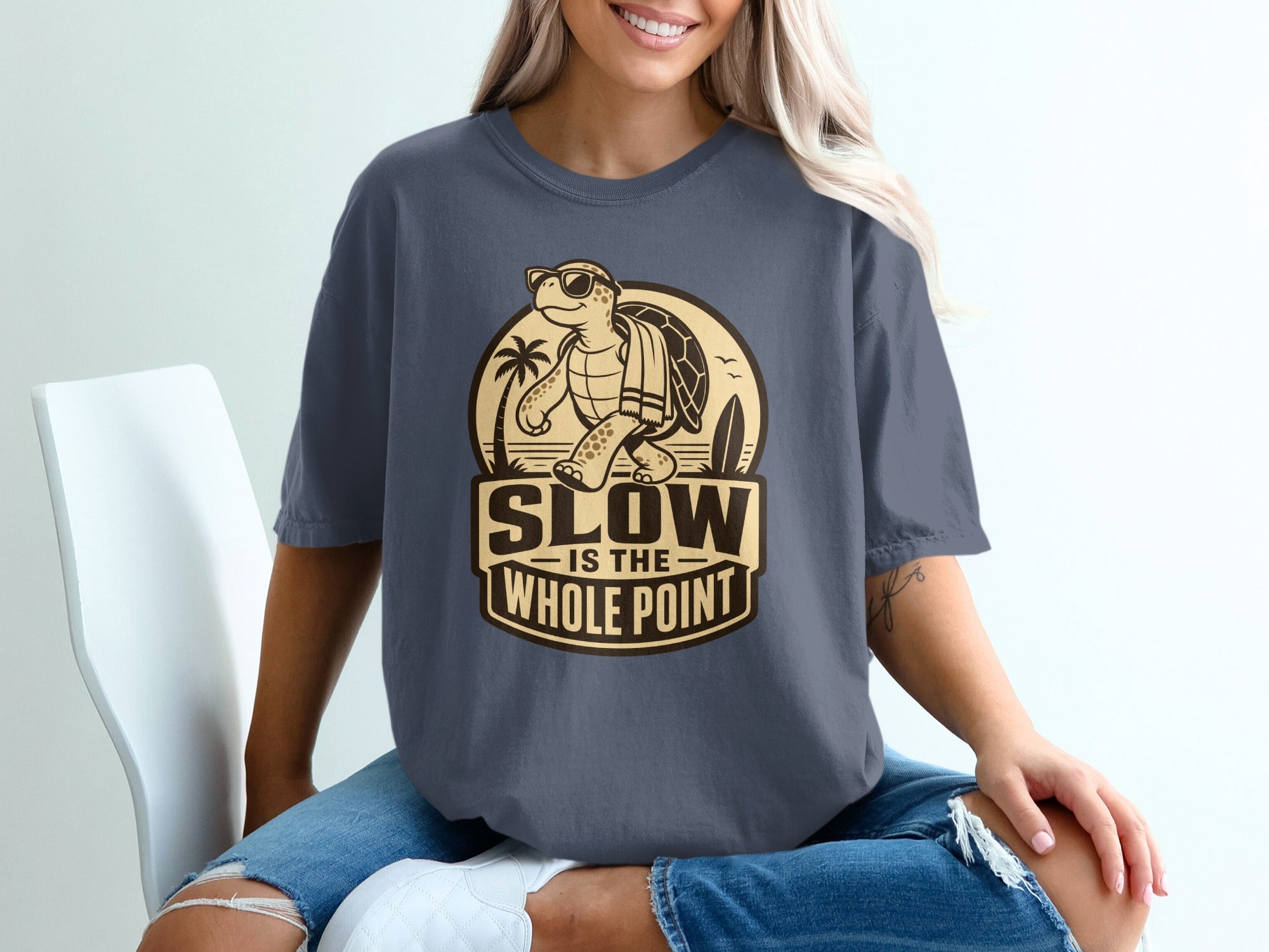T-shirt with graphic "Slow is the Whole Point" featuring a sunglasses-wearing turtle.
