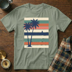 Olive green t-shirt with retro palm trees and sailboat on striped background.