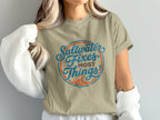 Tan t-shirt with circular "Saltwater Fixes Most Things" text design.