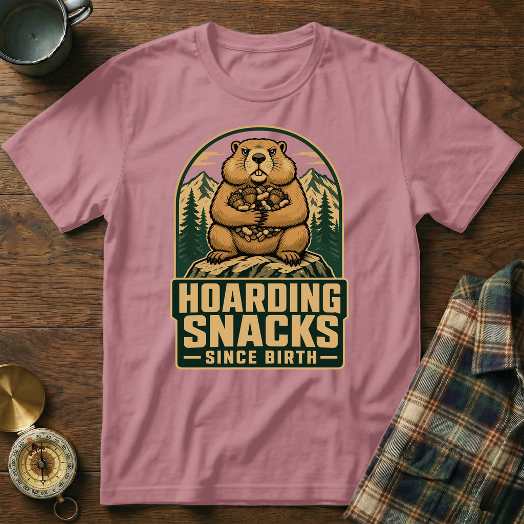 Groundhog hoarding snacks design on a pink t-shirt with text "HOARDING SNACKS SINCE BIRTH".