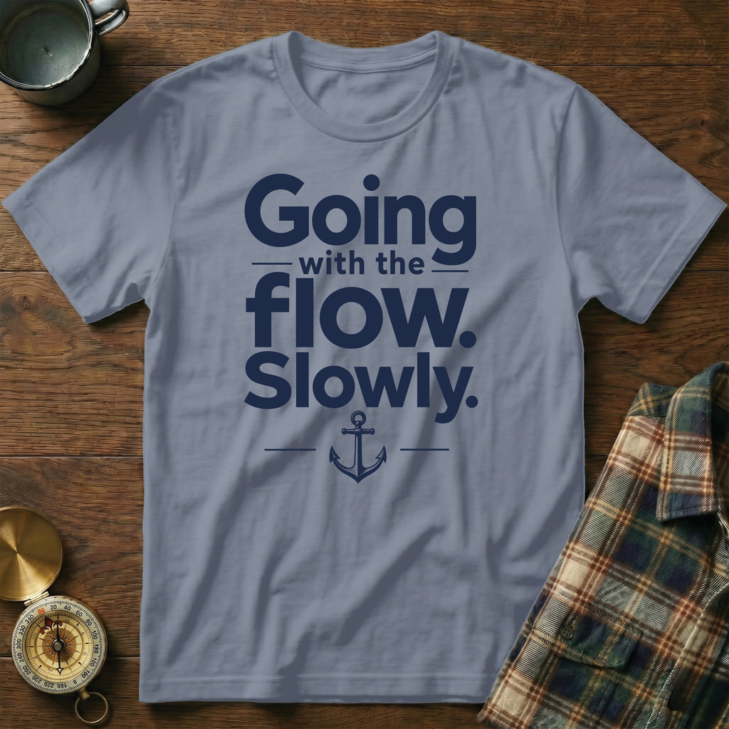 Slate blue t-shirt featuring navy blue text reading Going with the flow. Slowly. and an anchor graphic.