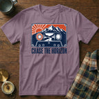 T-shirt with cassette tape design featuring mountains, sun, and road. Text: Chase the Horizon.