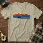 T-shirt with a vintage design of a person canoeing on a lake with mountains.
