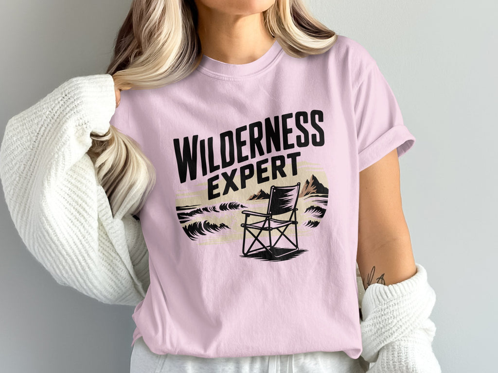 Pink t-shirt with "Wilderness Expert" text and chair illustration.