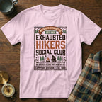 Pink t-shirt with "Exhausted Hikers Social Club" graphic and campfire scene.