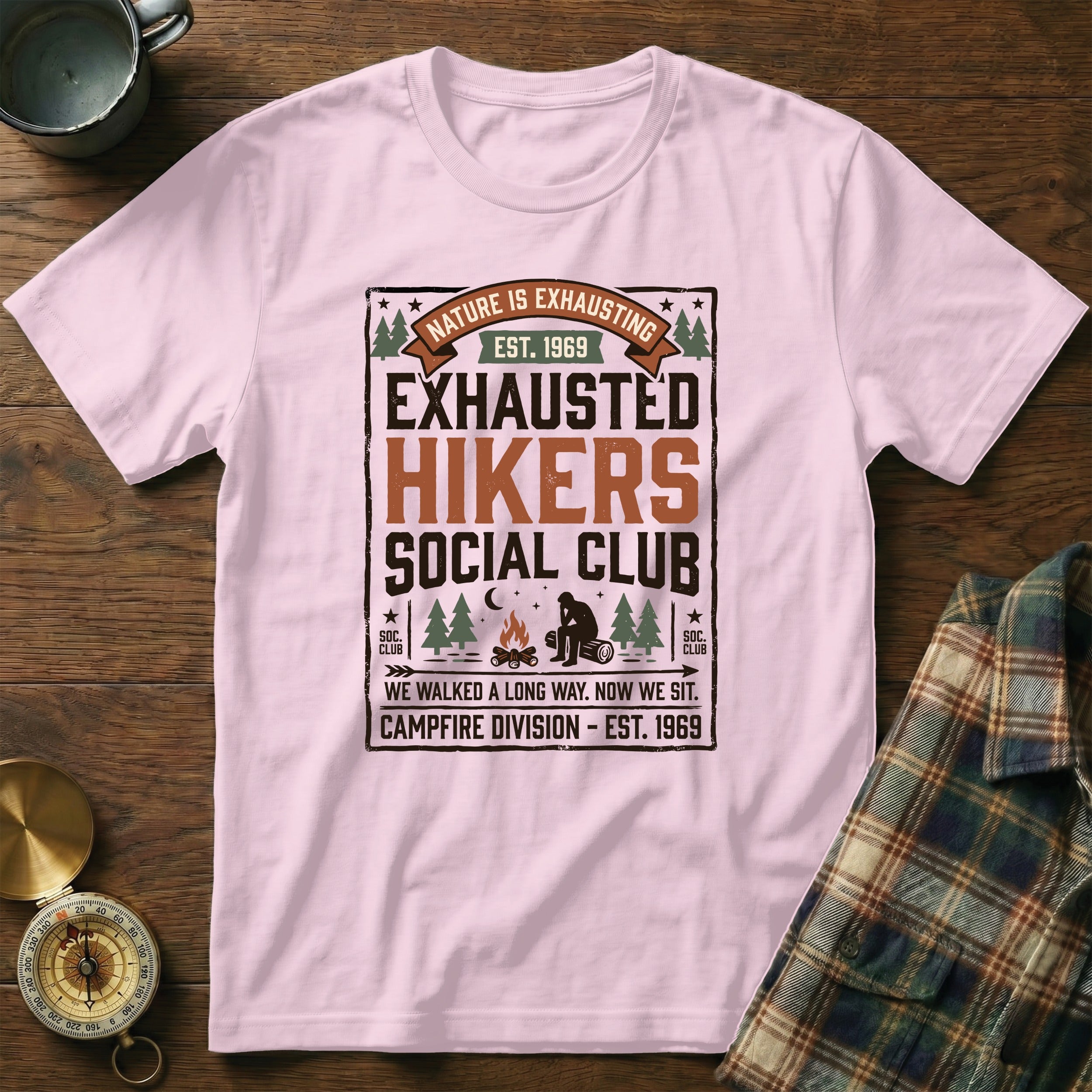 Pink t-shirt with "Exhausted Hikers Social Club" graphic and campfire scene.