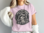 Pink t-shirt with raccoon graphic and text "Not A Photobomb. I'm The Whole Shot."