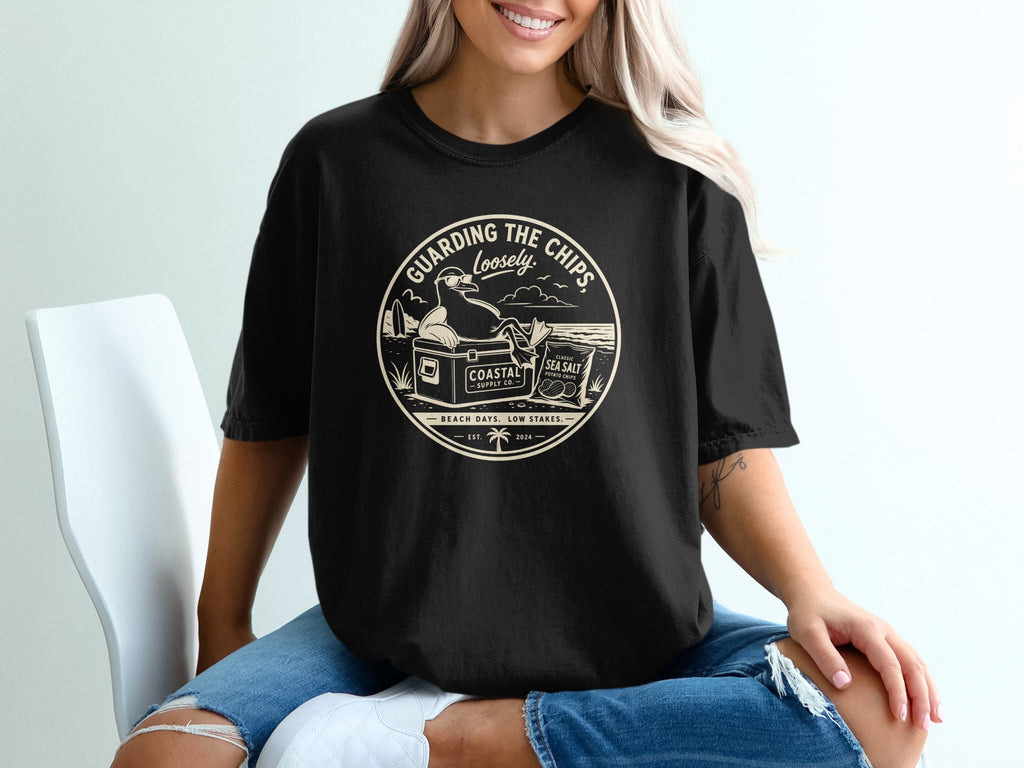 Black t-shirt with "Guarding The Chips Loosely" circular graphic.