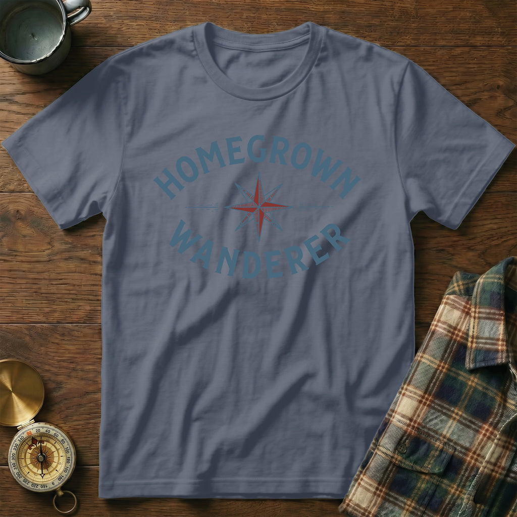 Blue t-shirt with "HOMEGROWN WANDERER" text, compass, and camping mug.