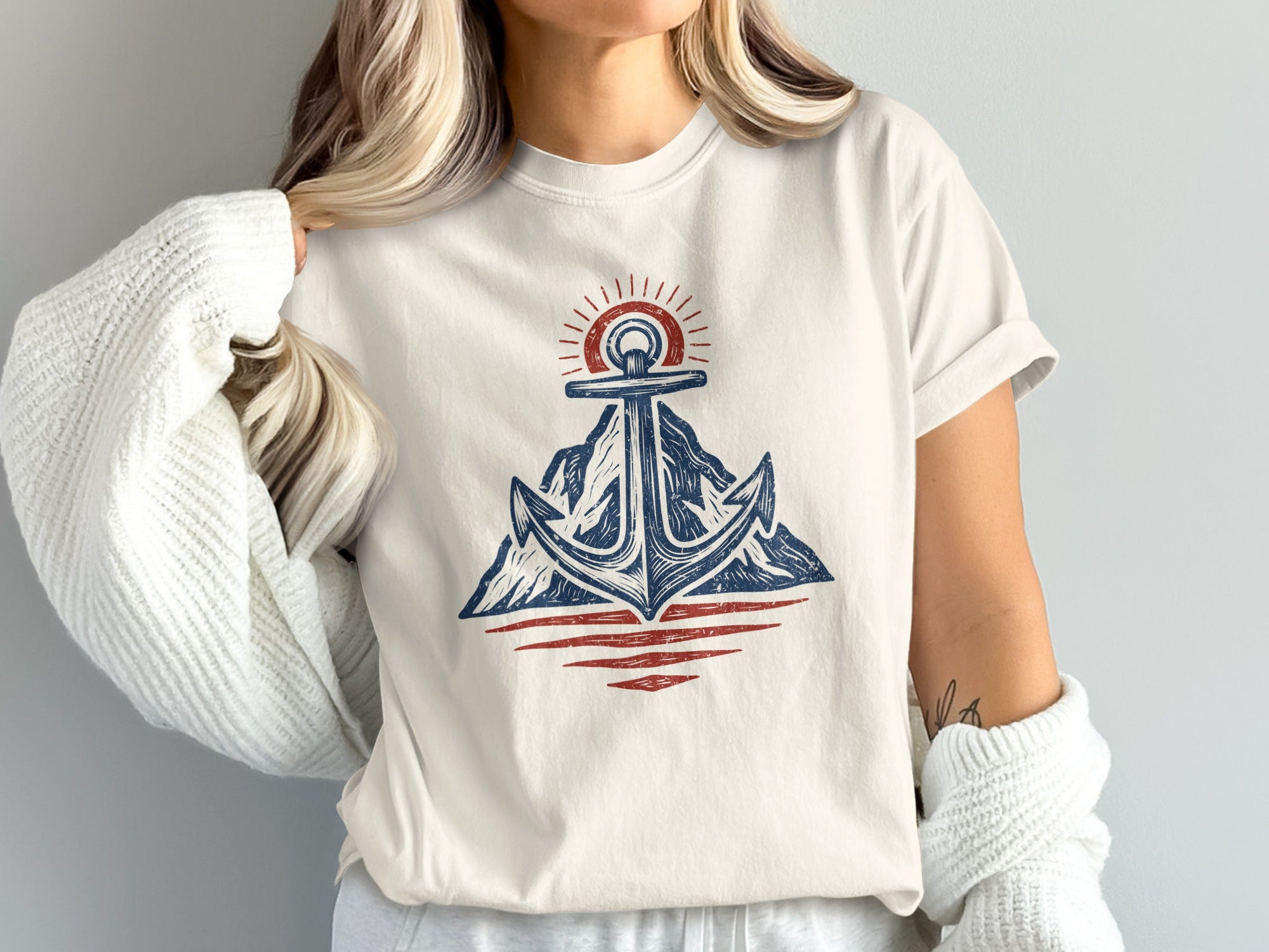 Anchor design with mountains and sun on a cream t-shirt.