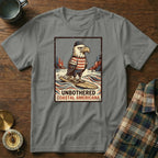 T-shirt with graphic of eagle in striped shirt on surfboard, text "Unbothered Coastal Americana".