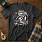 Black t-shirt with a raccoon graphic that says "Not a photobomb. I'm the whole shot."