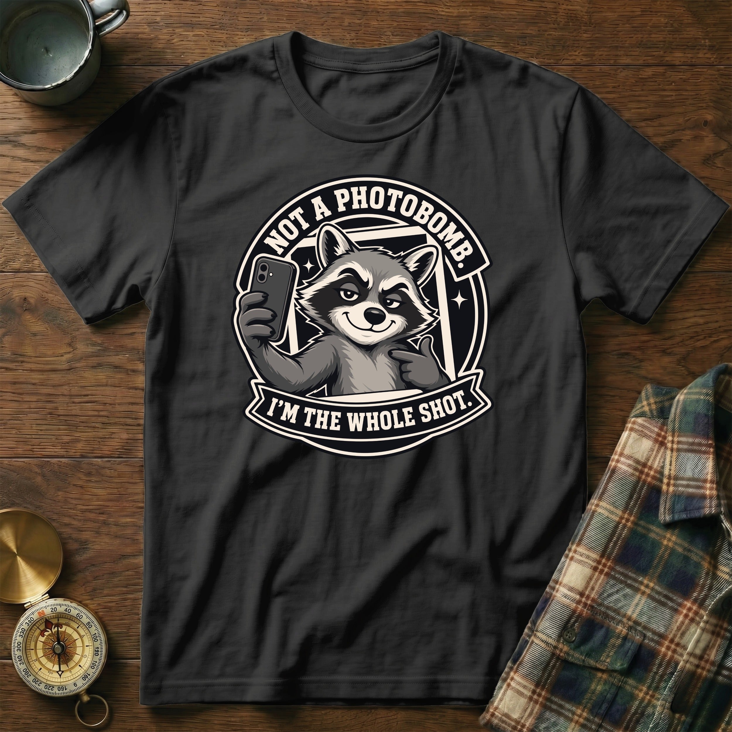 Black t-shirt with a raccoon graphic that says "Not a photobomb. I'm the whole shot."