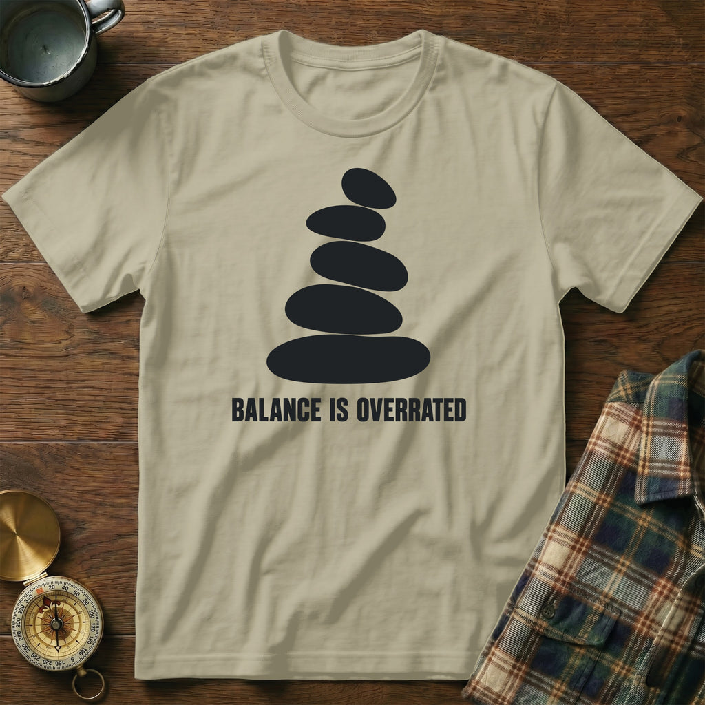 T-shirt with stacked rocks graphic and "BALANCE IS OVERRATED" text.