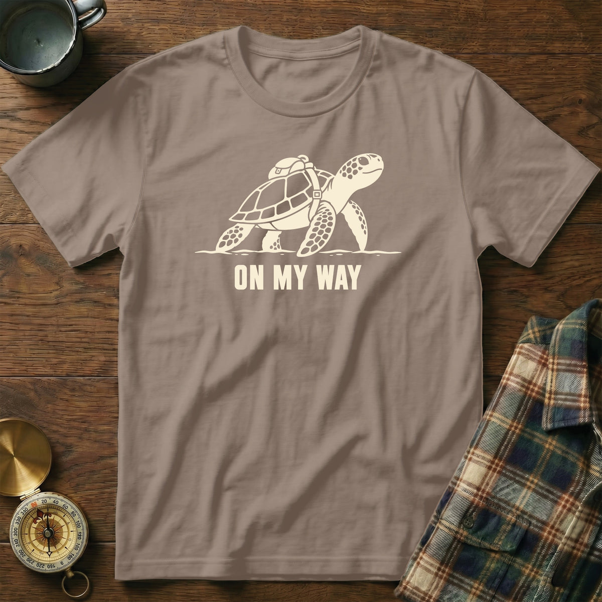 T-shirt with a graphic of a sea turtle wearing a backpack and the text "ON MY WAY".