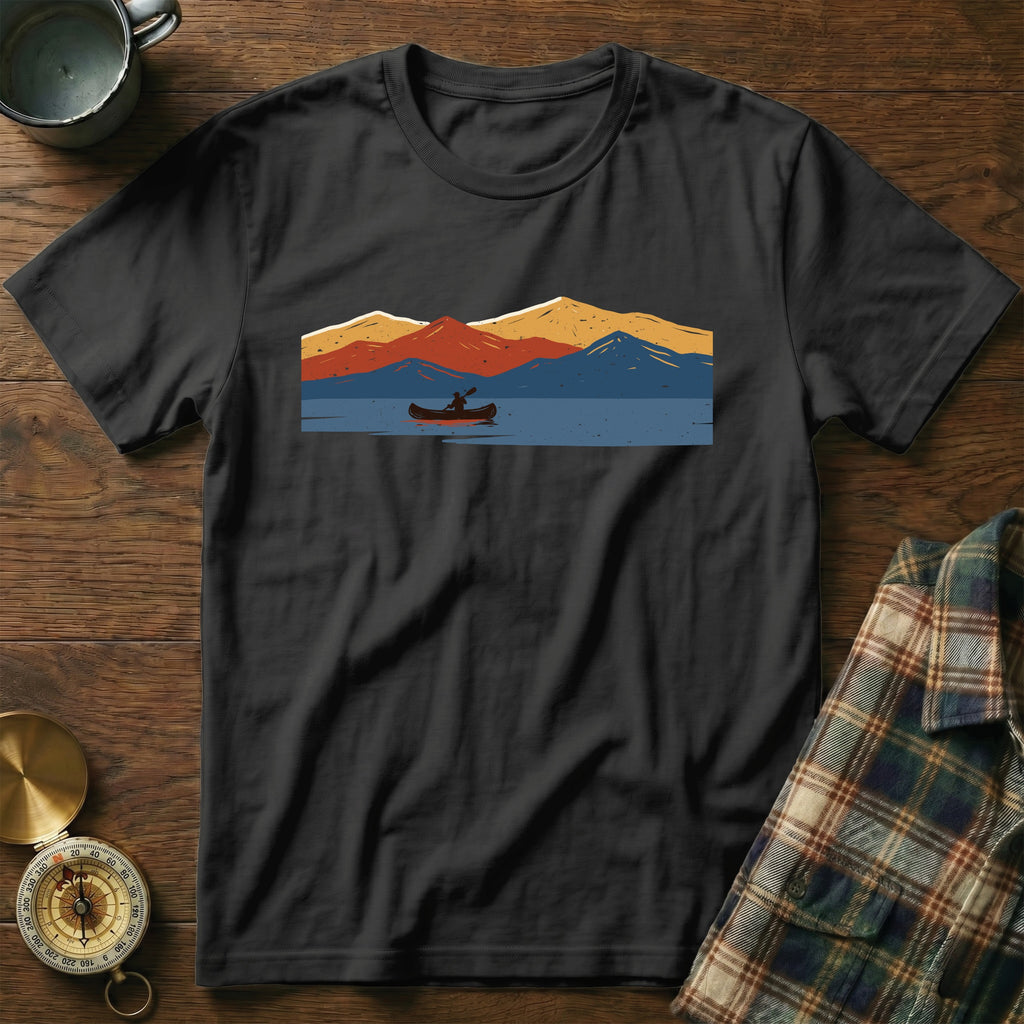 Black t-shirt with a graphic of a canoeist on a lake with mountains.