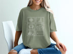 T-shirt with four square postage stamp designs: compass, waves, grass, sailboat.