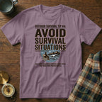 Purple t-shirt with "Avoid Survival Situations" text, outdoorsy graphic, and branded slogan.