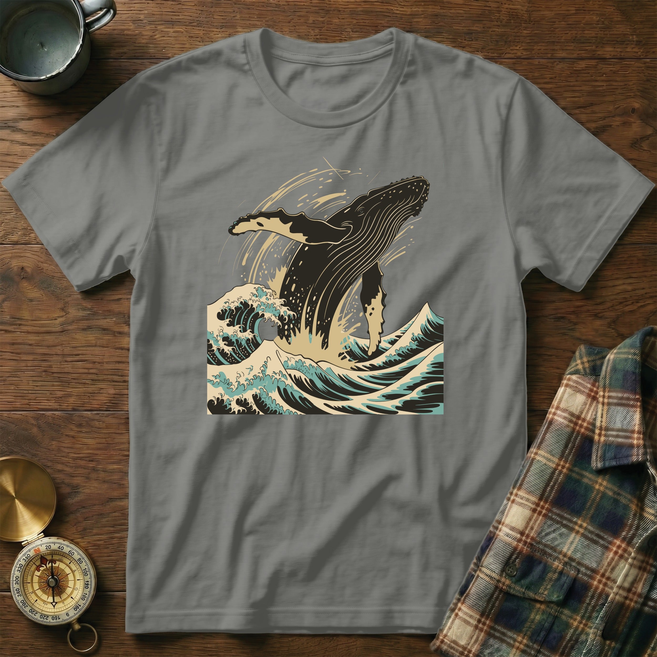 Gray t-shirt with leaping whale and ocean waves design.
