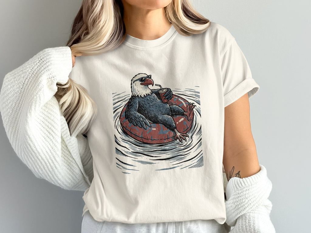 Bald eagle wearing sunglasses and drinking from a cup while floating on an inner tube.