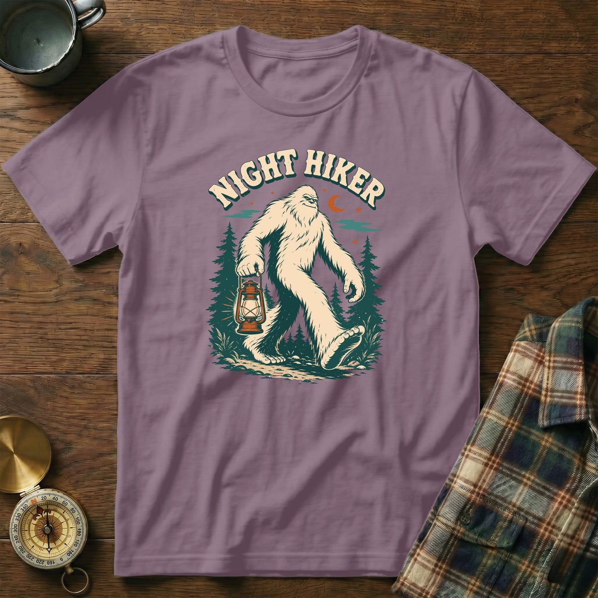 Bigfoot holding a lantern with "Night Hiker" text, set against a forest and night sky.