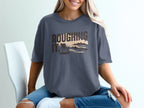 T-shirt with "Roughing It." text and a beach scene graphic.