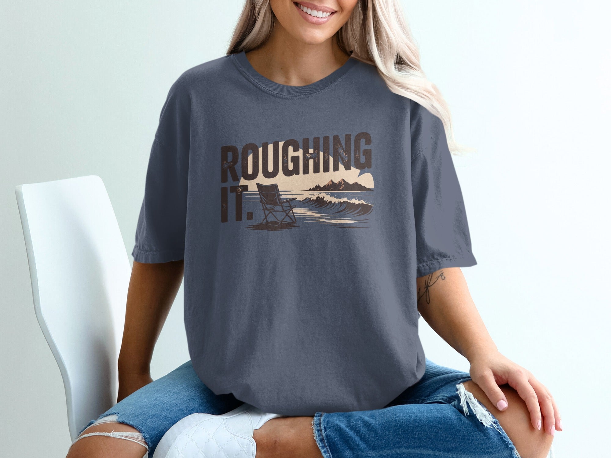 T-shirt with "Roughing It." text and a beach scene graphic.