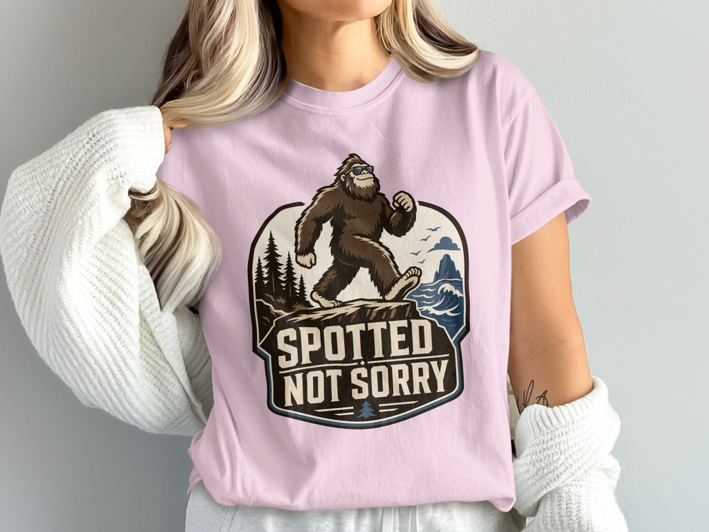 Bigfoot wearing sunglasses walking on a cliff with "Spotted Not Sorry" text.