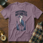Purple t-shirt with a heron, cattails, and the text "PROFESSIONALLY MOTIONLESS".