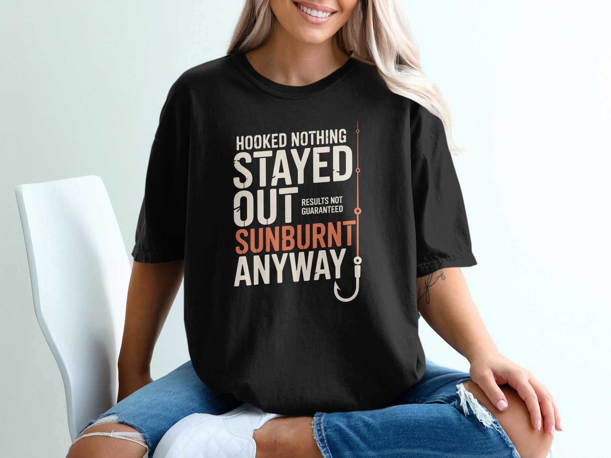 Black t-shirt with "Hooked Nothing Stayed Out Sunburnt Anyway" text and fishing hook.