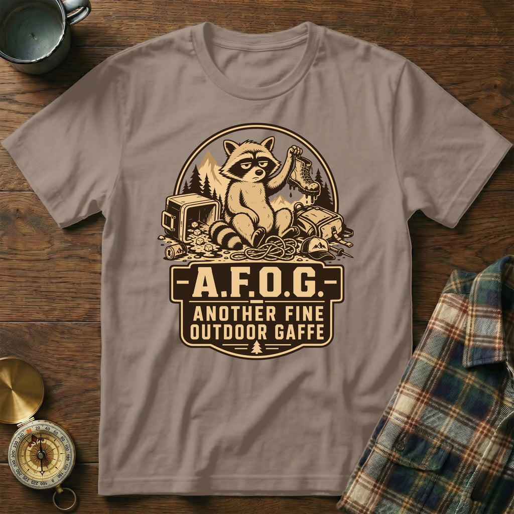 Brown t-shirt with a raccoon graphic and text: "A.F.O.G. ANOTHER FINE OUTDOOR GAFFE".