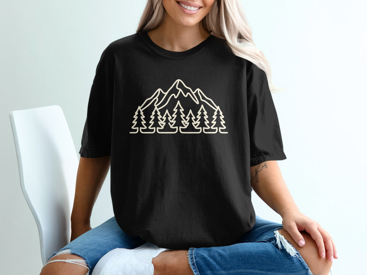 Black t-shirt with a line-art design of mountains and pine trees.