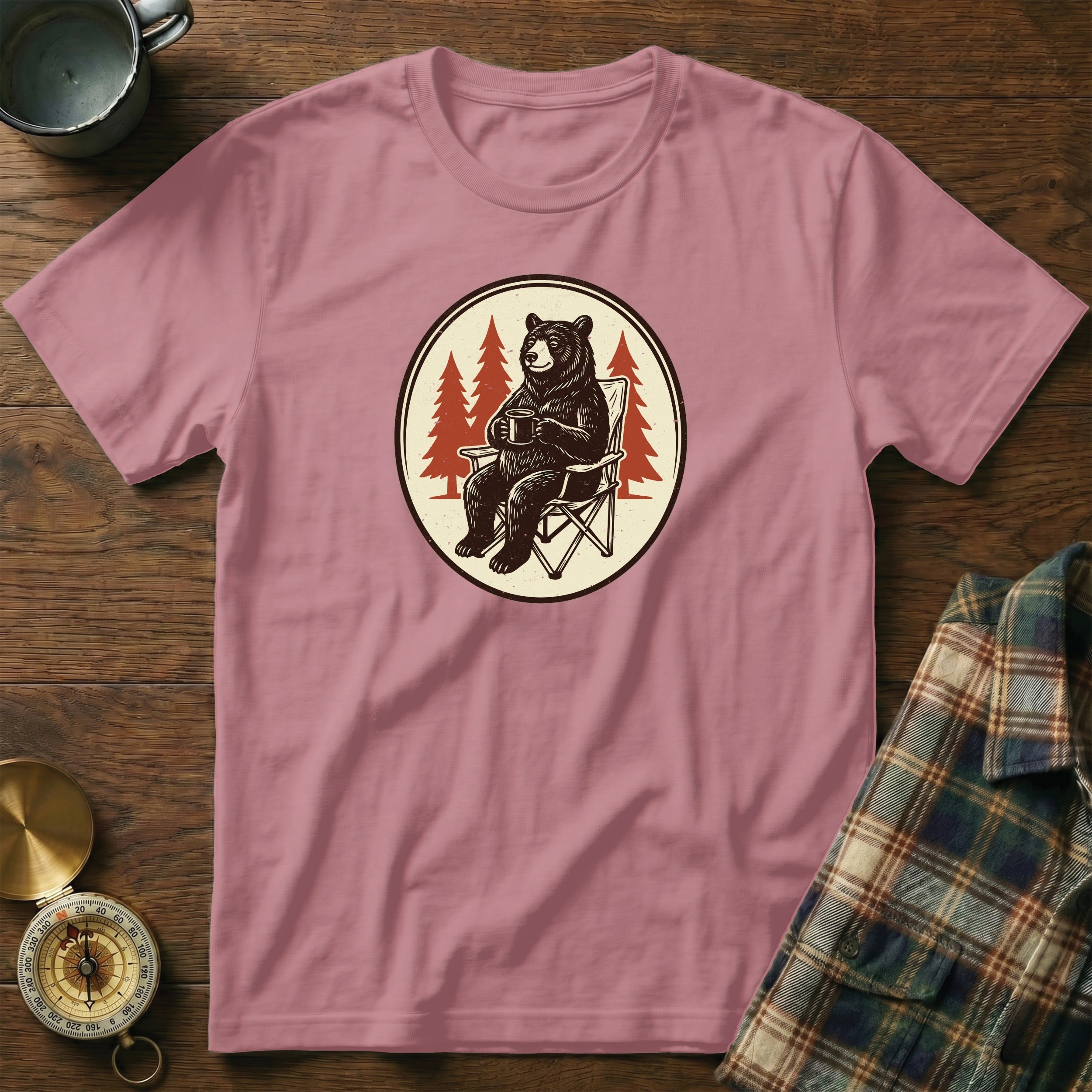 Pink t-shirt with a bear sitting in a chair holding a coffee mug.