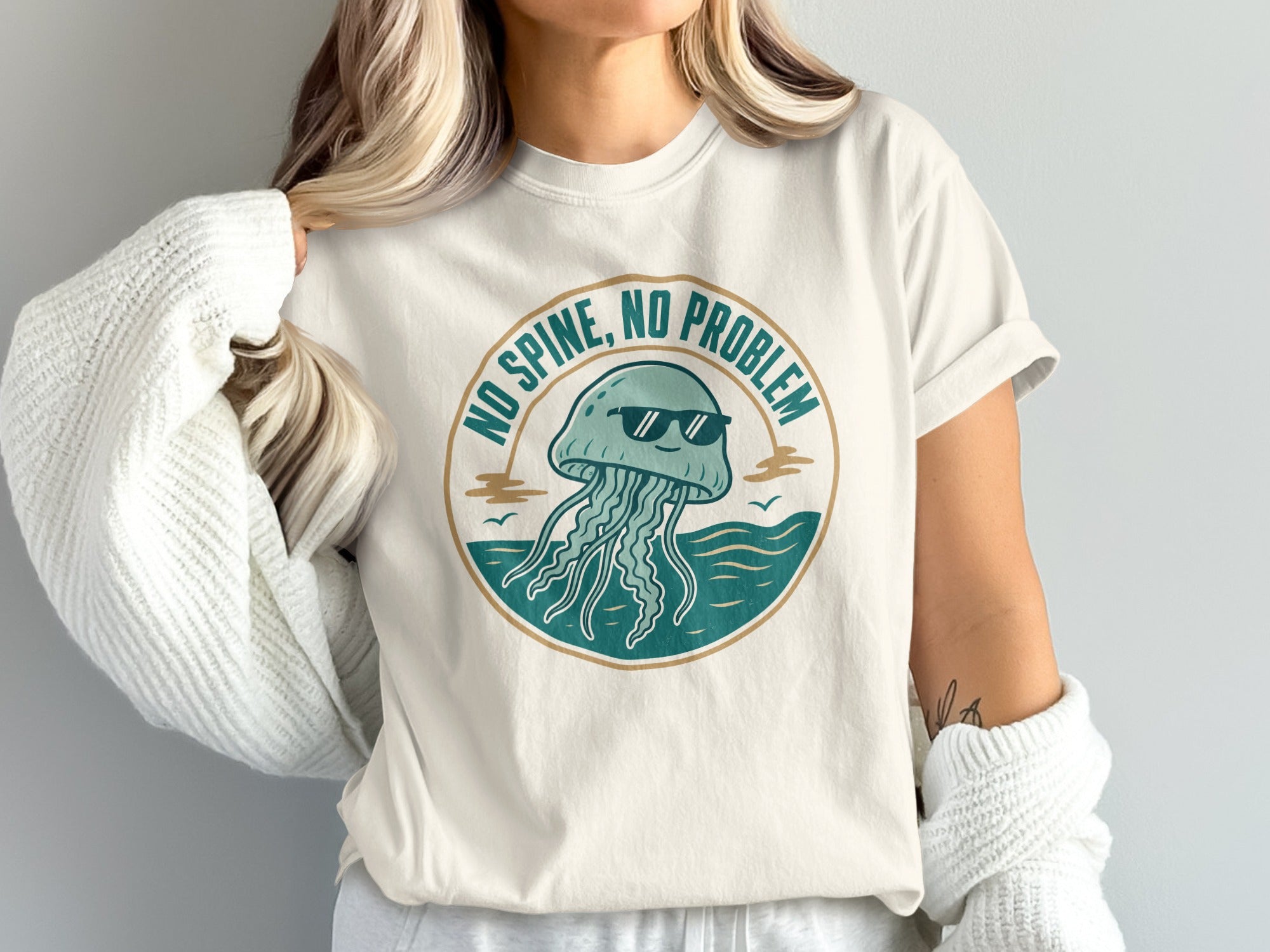 White t-shirt with graphic of a jellyfish wearing sunglasses and text "NO SPINE, NO PROBLEM".