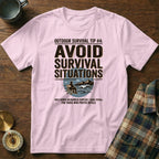 Pink t-shirt with "AVOID SURVIVAL SITUATIONS" graphic and ironic wilderness text.