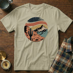 Desert landscape with cactus and mountains in a distressed circular graphic.