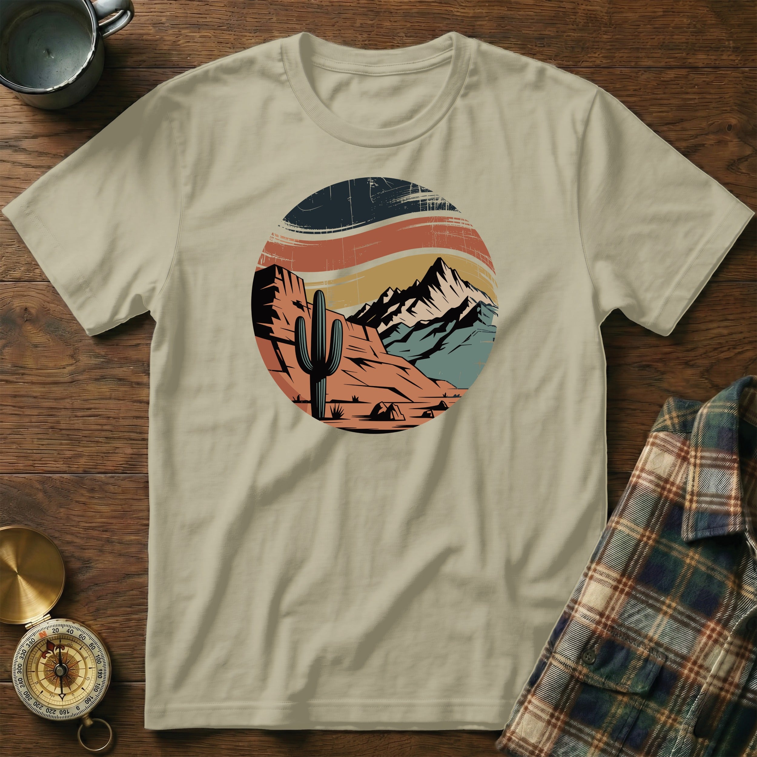 Desert landscape with cactus and mountains in a distressed circular graphic.