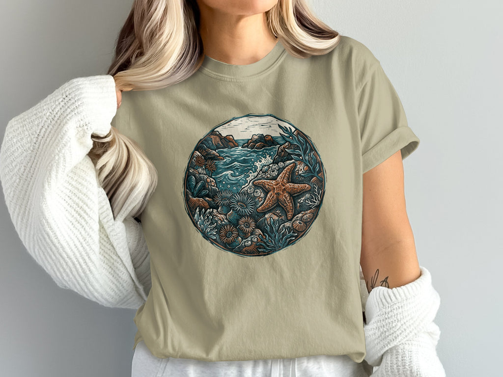 T-shirt with a circular graphic of a marine tide pool with starfish and plants.