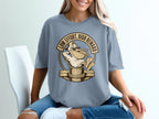 T-shirt with graphic of pelican wearing sunglasses holding fish, text "Low Effort, High Reward".