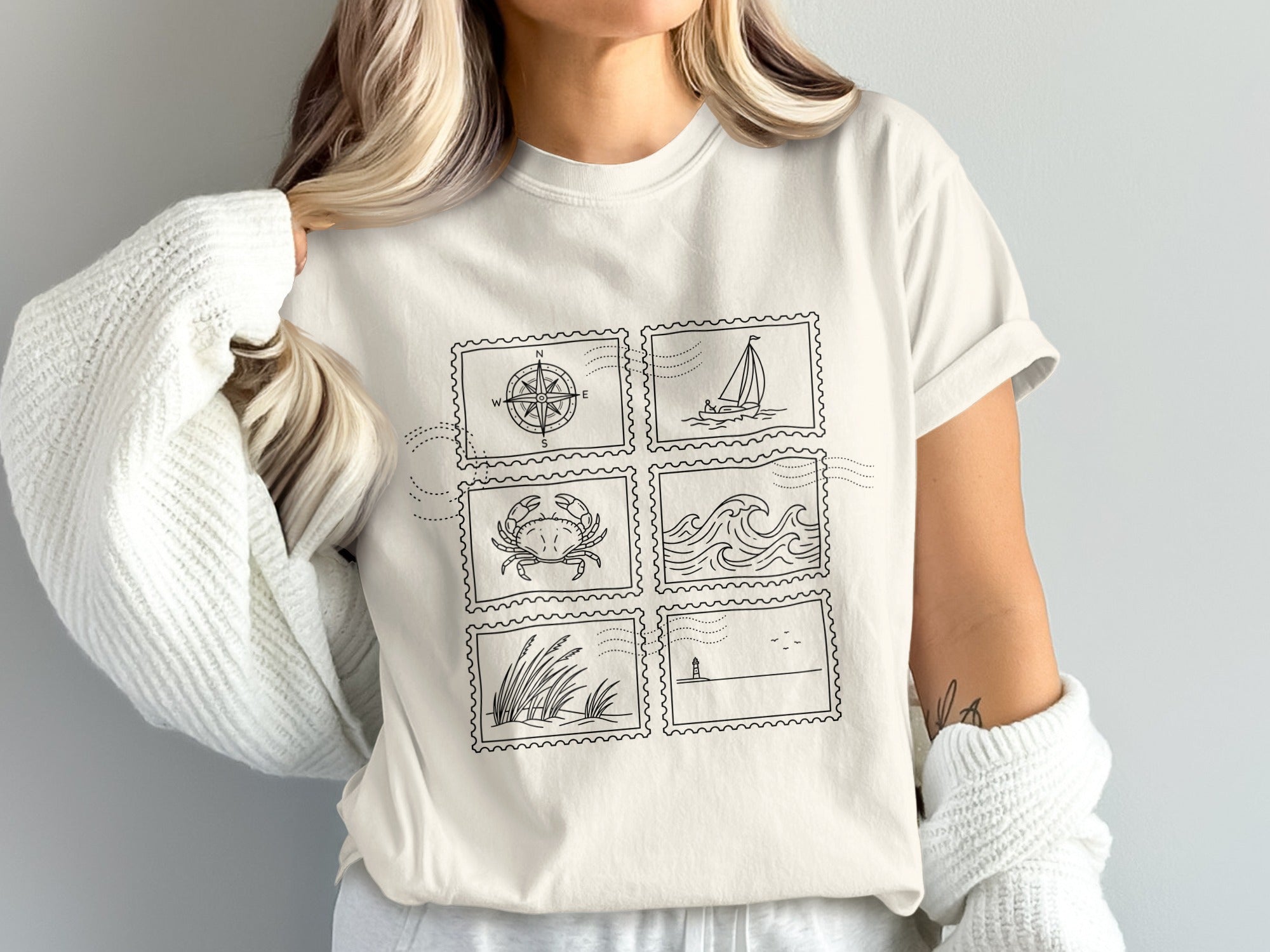 T-shirt with six postage stamp-style illustrations of nautical themes.