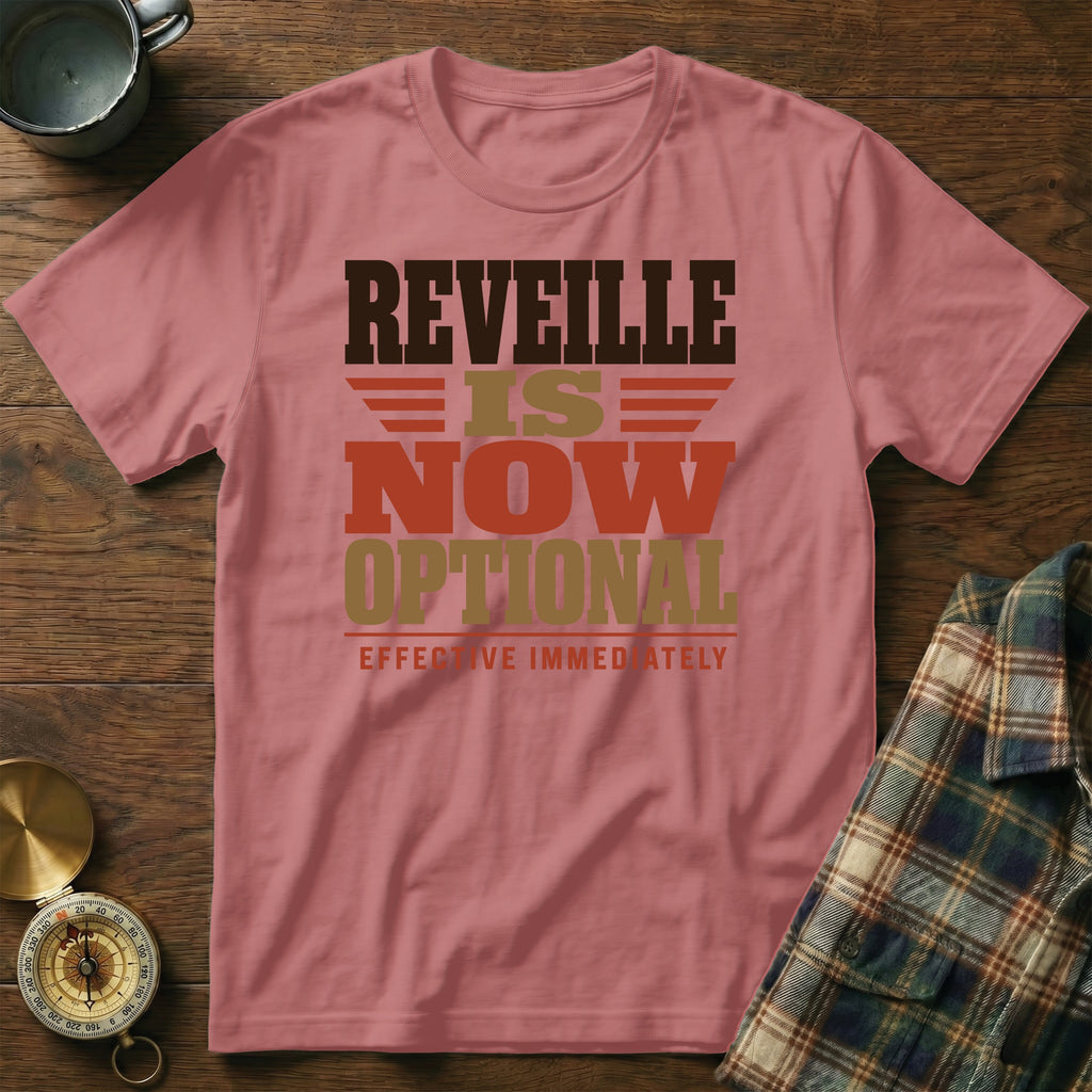Dusty rose t-shirt featuring the black, brown, and gold text REVILLE IS NOW OPTIONAL EFFECTIVE IMMEDIATELY.
