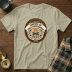 Cream t-shirt with a circular badge graphic about surviving adult conversation.