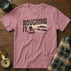Pink t-shirt with "ROUGHING IT." text and beach chair graphic.