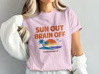 Pink t-shirt with "SUN OUT BRAIN OFF TEMPORARILY" and a beach sunset graphic.