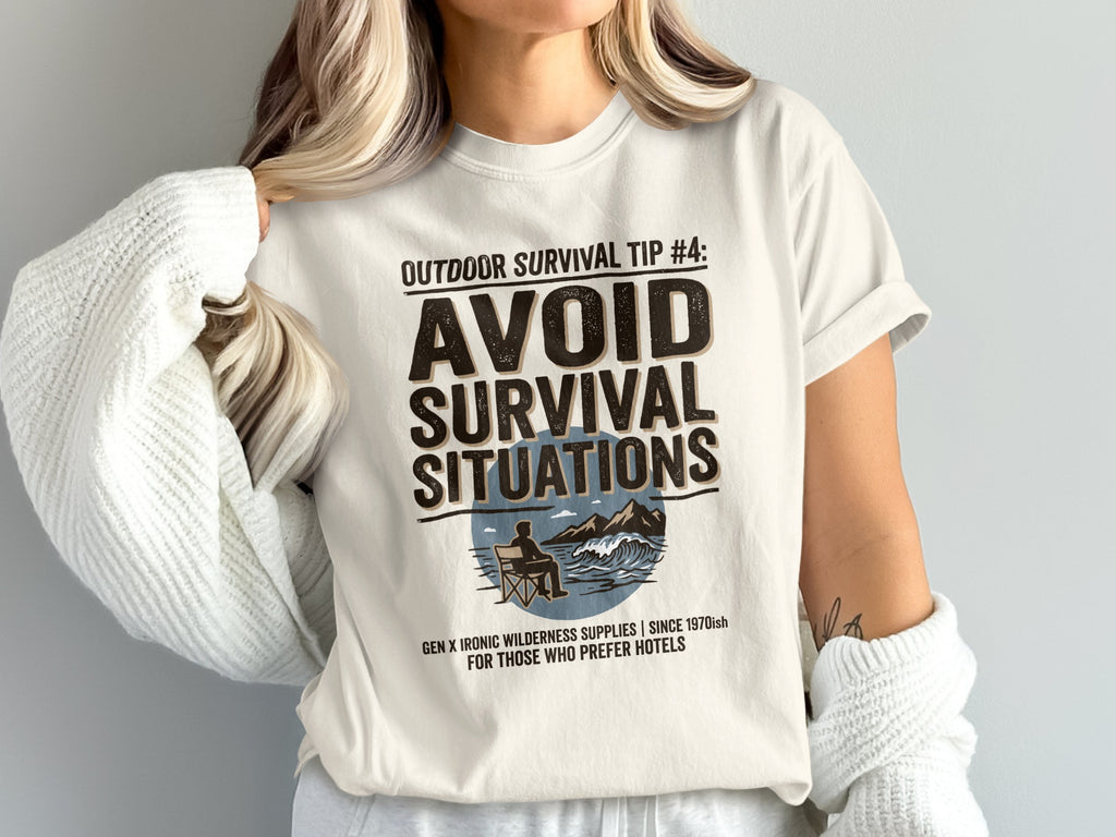 White t-shirt with "Outdoor Survival Tip #4: Avoid Survival Situations" and a scenic graphic.
