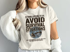 White t-shirt with "Outdoor Survival Tip #4: Avoid Survival Situations" and a scenic graphic.
