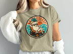 T-shirt graphic of a smiling cartoon cocktail in sunglasses relaxing on a deck chair.