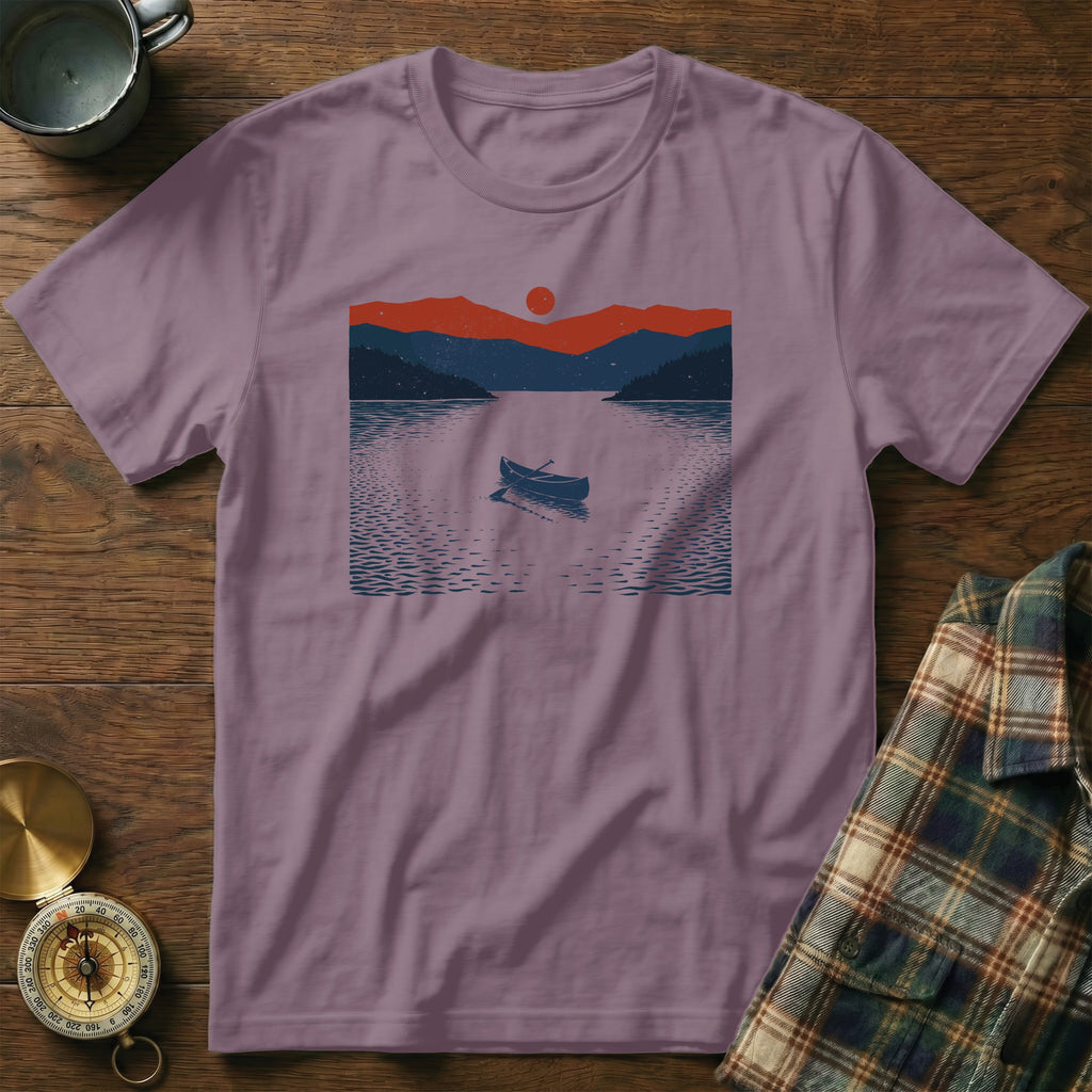 T-shirt with lake scene graphic featuring a canoe and mountains under a sun.