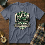 T-shirt with a "Nowhere Near Done Exploring" nature graphic featuring mountains and trees.