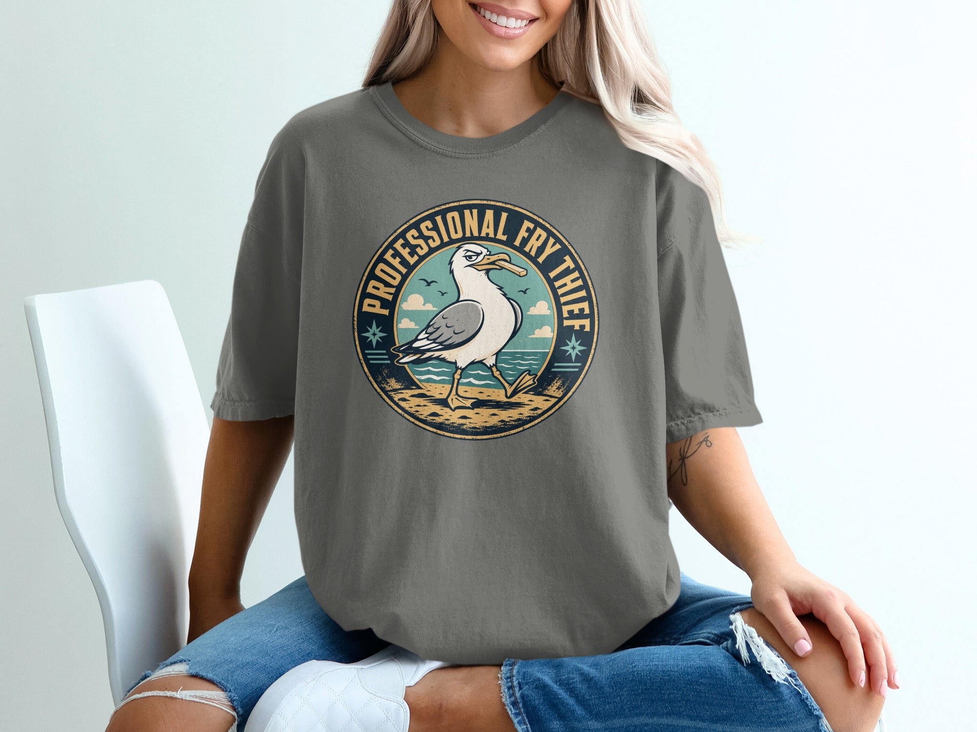 Seagull in circular graphic with text "Professional Fry Thief" on t-shirt.